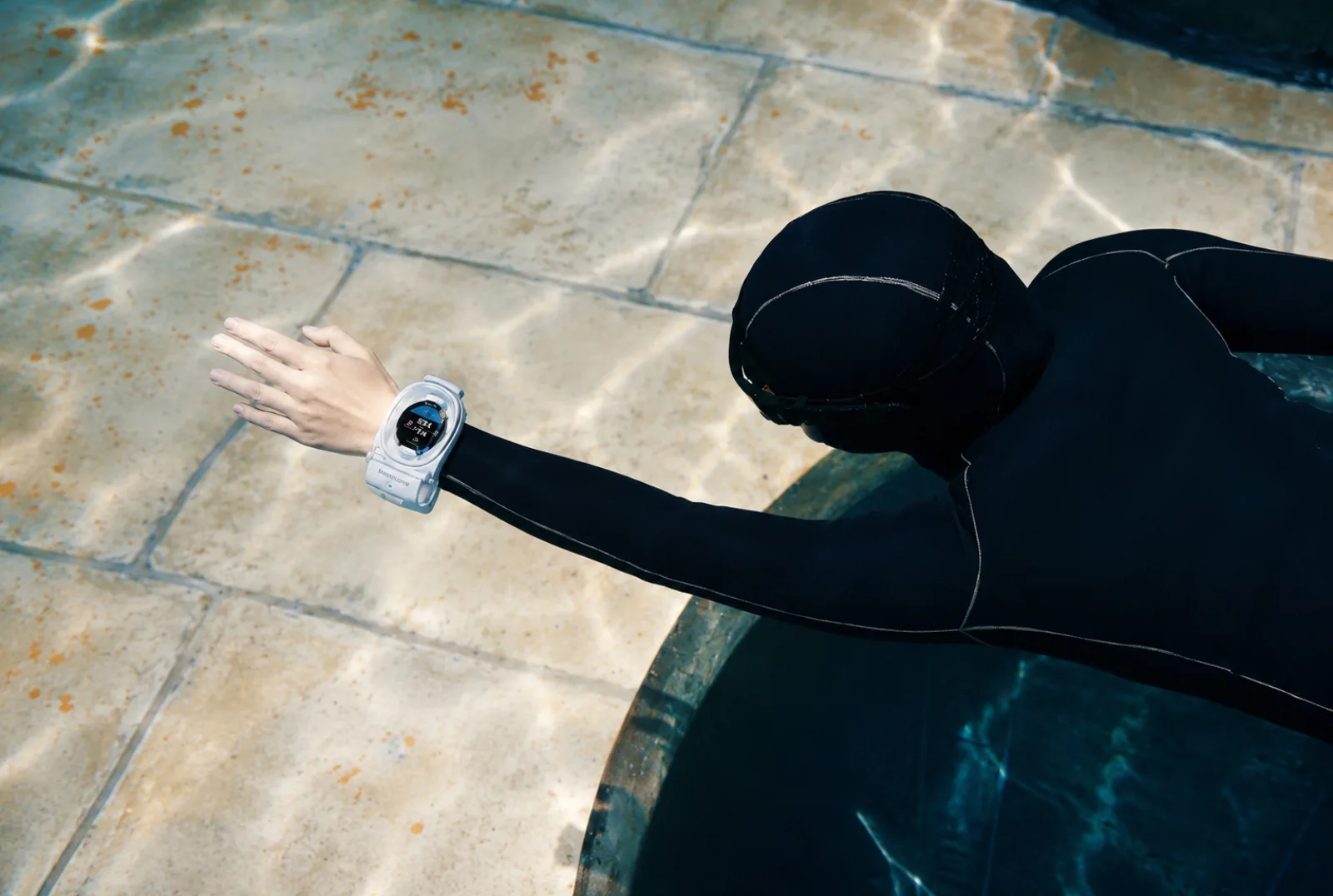 Freediver wearing Watch Dive at the pool edge