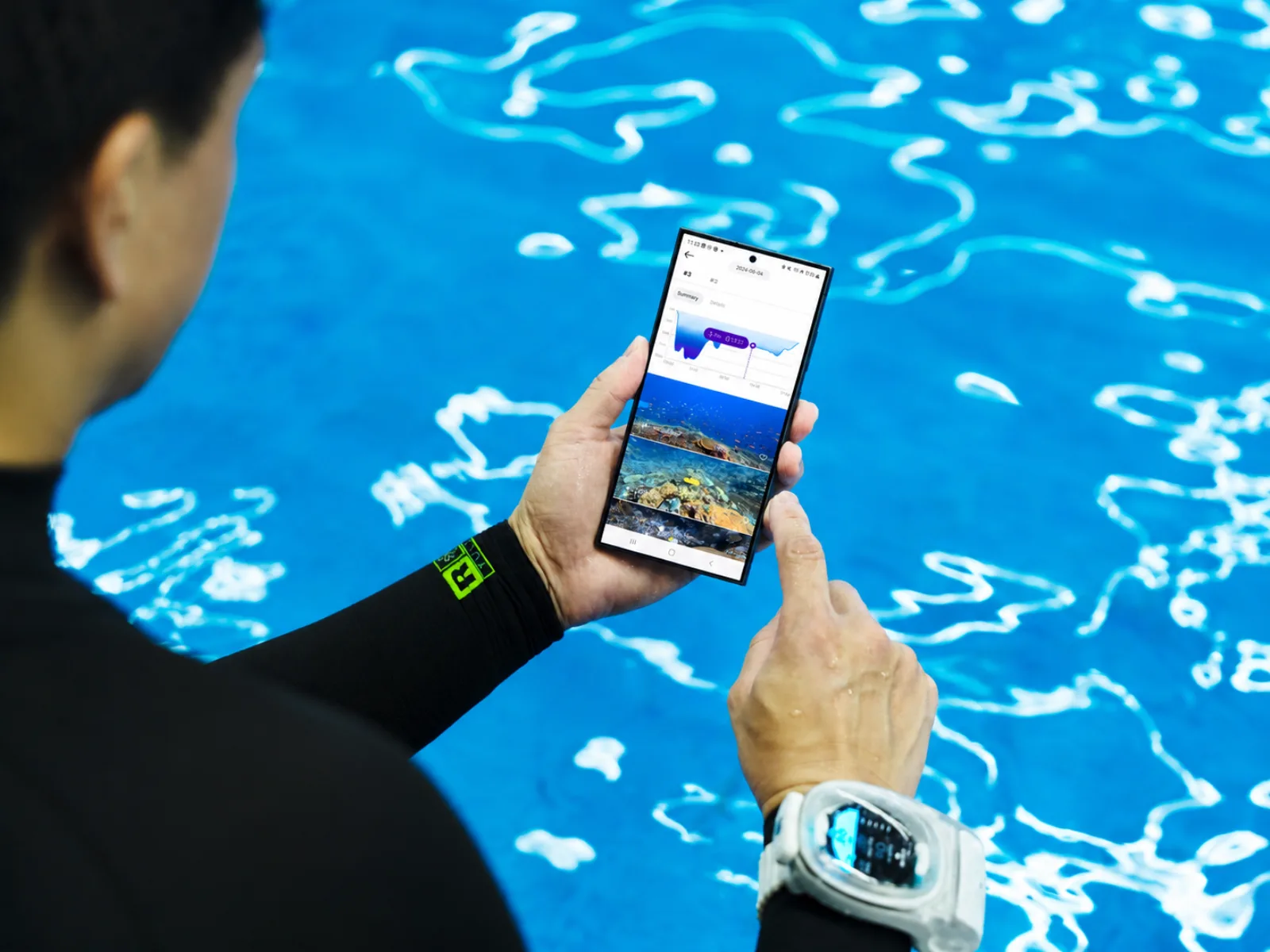 Diver reviewing dive log in the connected app poolside
